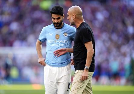 Ilkay Gundogan and Pep Guardiola after a soccer match.