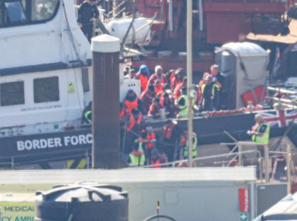 Migrants arriving at a port on a Border Force boat.