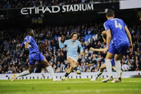 Jack Grealish scoring a goal during a soccer match.
