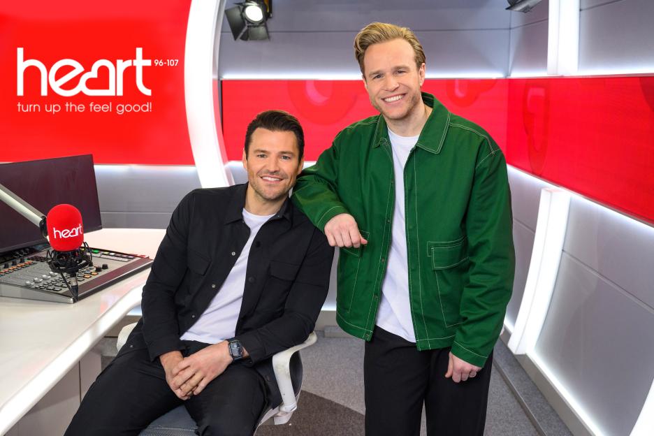 Olly Murs and Mark Wright posing for a photo in a Heart radio studio.