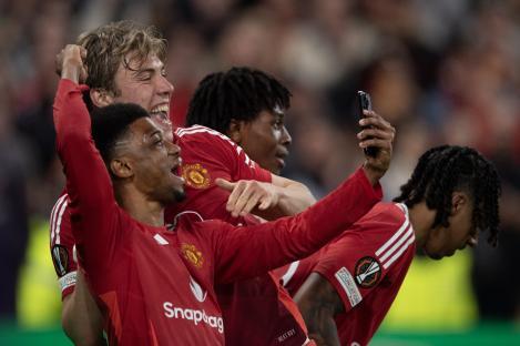 Manchester United players taking a selfie after a goal.