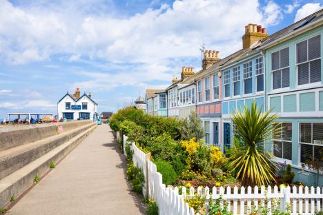 Row of colorful houses and a pub by the sea.