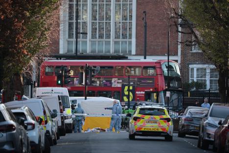 Forensic officers at a London crime scene.
