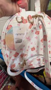 Mini backpack with pink teddy bear and bow print, £12.99 price tag.