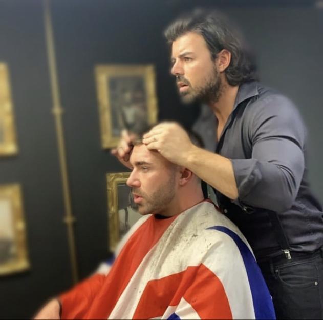 Barber cutting a man's hair.