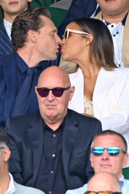 Tom Hiddleston and Zawe Ashton kissing at Wimbledon.