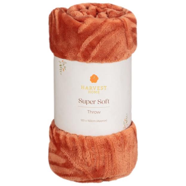 Rolled orange throw blanket.