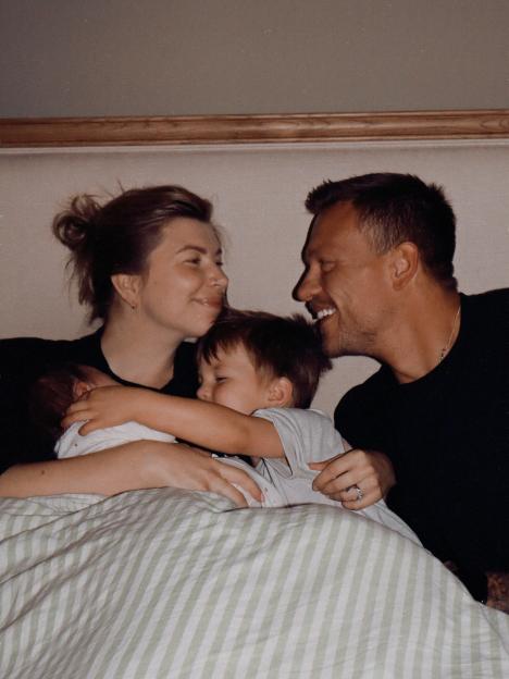 Family photo of Olivia and Alex Bowen with their two children, including a newborn baby girl.