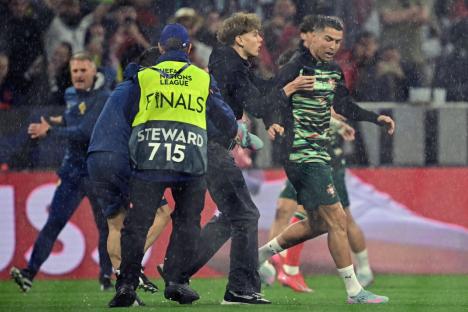 Major security breach as Cristiano Ronaldo is grabbed by pitch invader before guards are forced to intervene