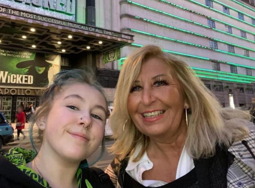Photo of Olivia Bettney and Susan Burfoot in front of the Apollo Victoria Theatre.