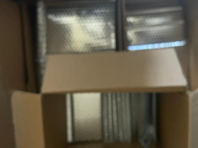 Blurry photo of cardboard boxes and bubble wrap.