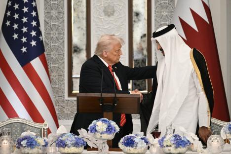 Donald Trump shaking hands with the Emir of Qatar.