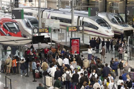 Passengers waiting at a train station in Malaga, Spain.