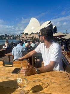 Man on a date in Sydney, with the Sydney Opera House in the background.