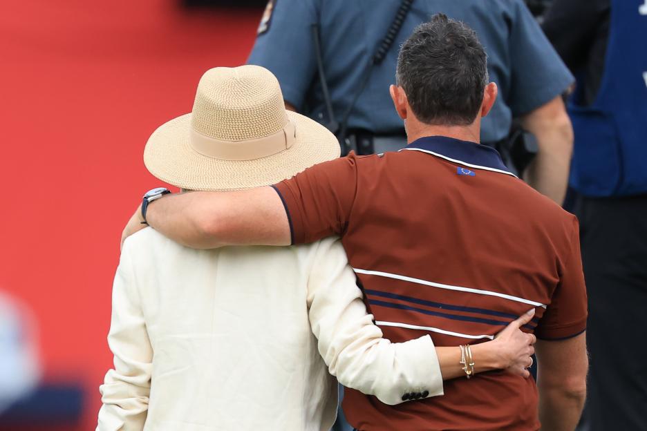Rory McIlroy and his wife Erica walking off the golf course.