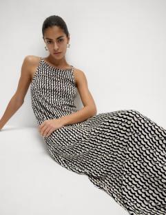 Model wearing a printed midi beach dress.