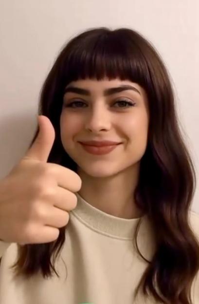 Woman giving thumbs up.