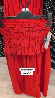 Red summer co-ord on a hanger.