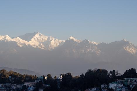 bright morning sun on Kanchenjunga mountain in the Himalayas taken from Darjeeling, India with the city in the foreground