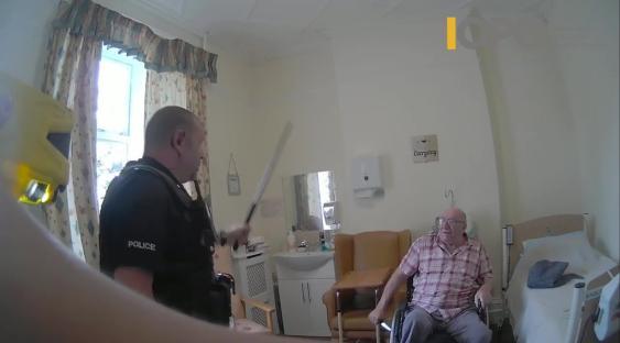 Bodycam footage of police officers using force against a 92-year-old man in a wheelchair.
