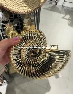 Gold nautilus shell-shaped handbag.