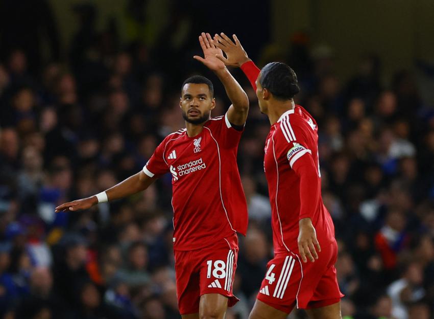 Liverpool's Cody Gakpo and Virgil van Dijk celebrate after Gakpo scored a goal.