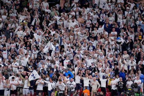 Tottenham Hotspur fans cheering at a UEFA Europa League match.