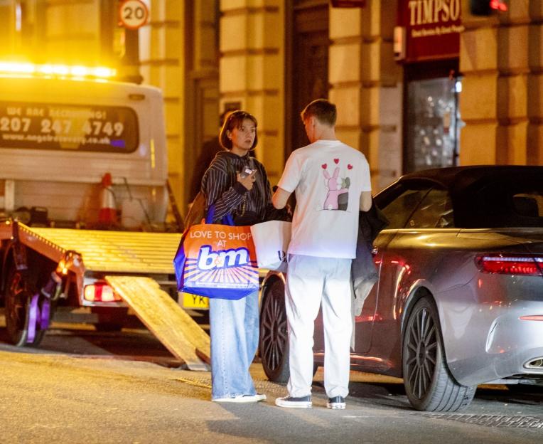 Jamie Borthwick and Georgina Shave with a tow truck and their broken-down Mercedes.