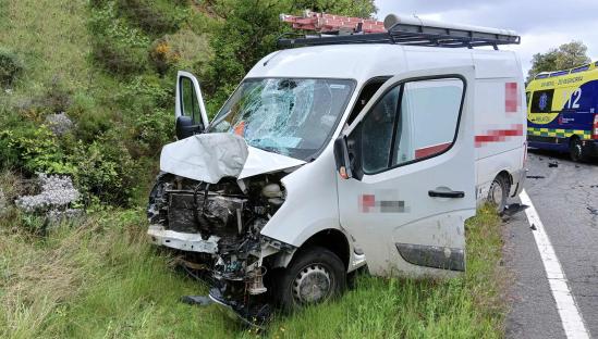 Damaged van at the scene of a fatal motorcycle accident.