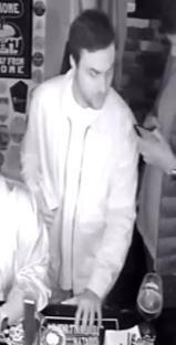 Black and white security camera image of a man police wish to speak to regarding a sexual assault.