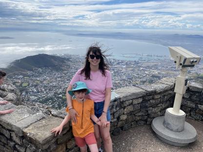 Woman and child overlooking Cape Town from a mountaintop.