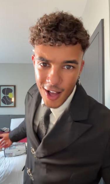Freddie Fraser in a suit and tie looking at the camera with an open mouth.