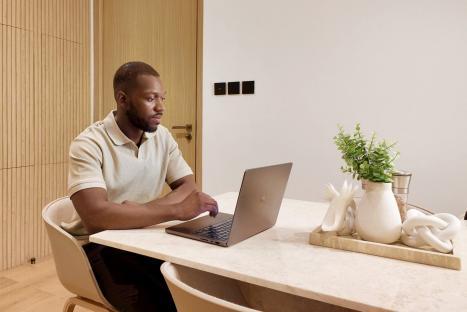 Man working on laptop at home.