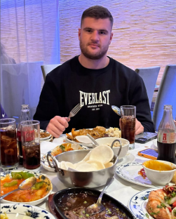 Man eating Chinese food.