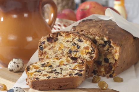 Fruitcake slices on a wooden board.