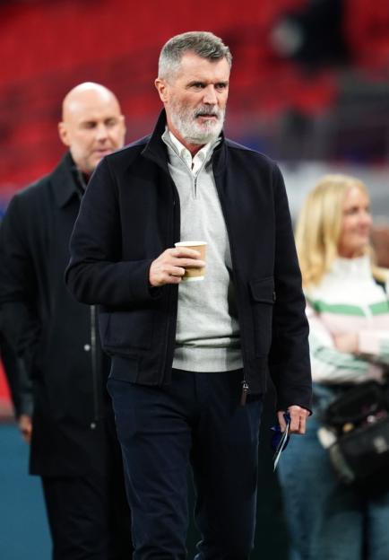 Roy Keane holding a coffee cup at Wembley Stadium.