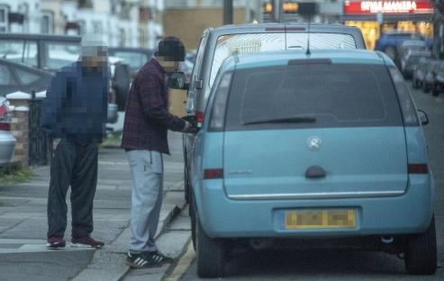 Undercover reporter buying heroin from a dealer.