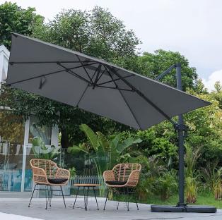 Large gray cantilever patio umbrella over patio furniture.