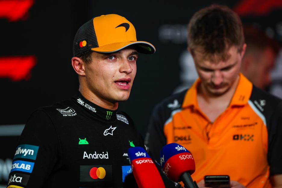 Lando Norris speaking into two Sky Sports microphones.
