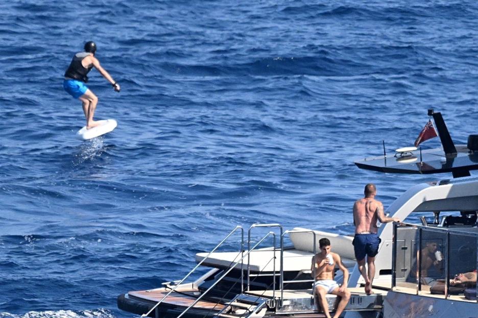 David Beckham flyboarding near a yacht.