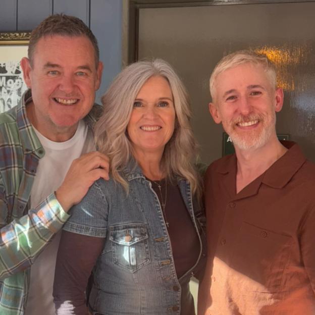 Three people smiling for a photo.