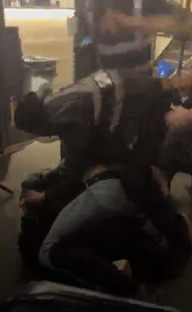 A bouncer being punched during a bar brawl.