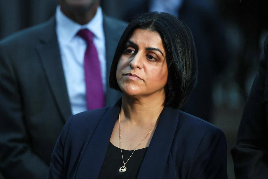 British Home Secretary Shabana Mahmood looks on.