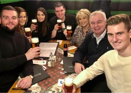 Eamonn Holmes' family enjoying drinks together at a restaurant.