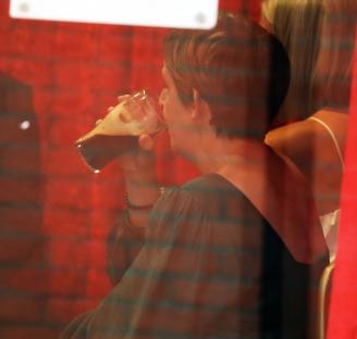 Julie Hesmondhalgh drinking beer at an awards ceremony.