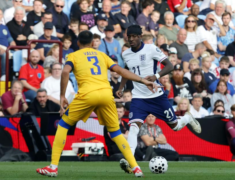 Noni Madueke of England dribbling the ball during a soccer match.