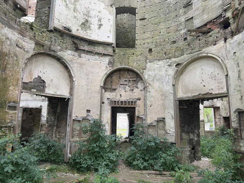 Ruined interior of Dalquharran Castle overgrown with vegetation.