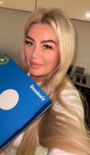 Woman holding a Domino's pizza box.