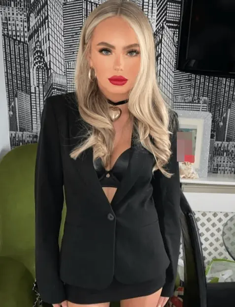 Woman in black blazer and skirt.