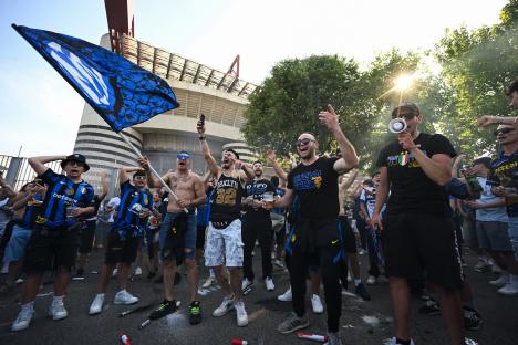 Inter Milan fans cheering outside the San Siro stadium.